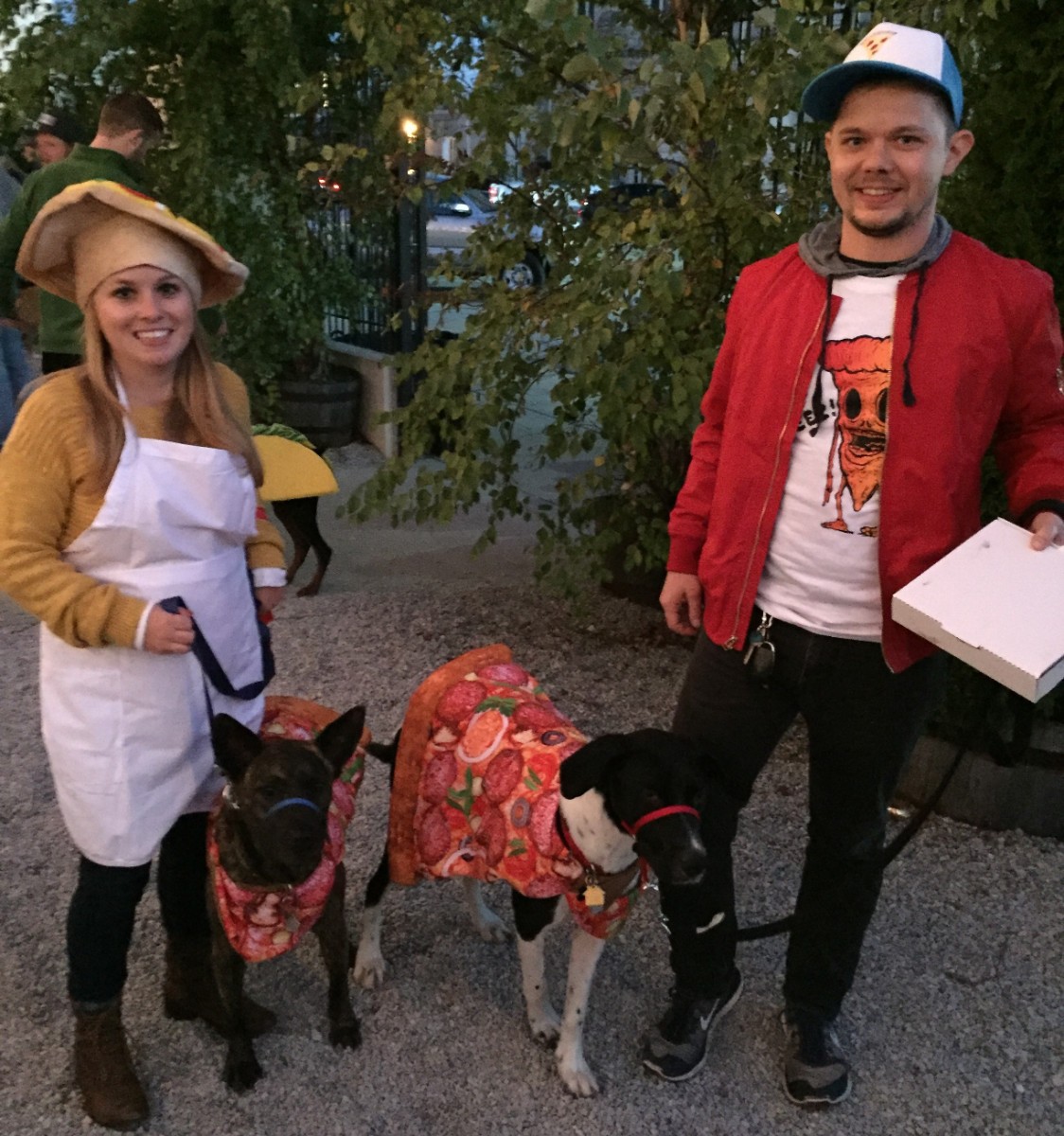 Katie and John with their dogs Sasha and Mac dressed up as a pizza delivery operation.